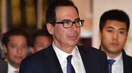 US Treasury Secretary Steven Mnuchin returns to a hotel with members of his negotiation team after trade talks in Beijing on February 14, 2019. - US and Chinese negotiators on February 14 kicked off two days of high-level talks that President Donald Trump says could decide whether he escalates the bruising tariff battle between the world's two biggest economies. (Photo by GREG BAKER / AFP)