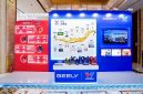 A display booth featuring Valvoline GEELY collaboration, showcasing co-developed lubricants and a timeline of their partnership, with product bottles arranged on a central table.